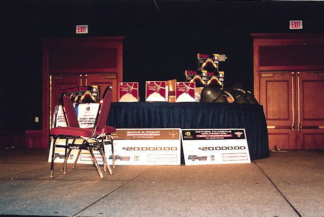 Trophies and prize money for the CTF, 1v1, and RTCW tournies.  The chairs were not part of the prize package. :) (qcon2003_25.jpg, 640w x 430h )
