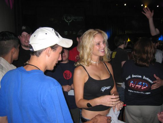 One of the Quake Girls hands out swag (qc043029.jpg, 573w x 430h )