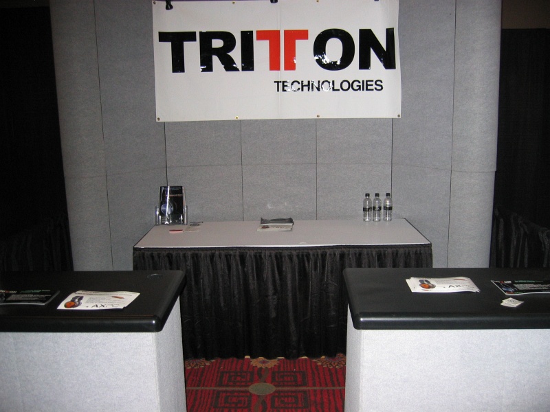 Triton Technologies had a sparsely decorated booth. (qc071041.jpg, 800w x 600h )